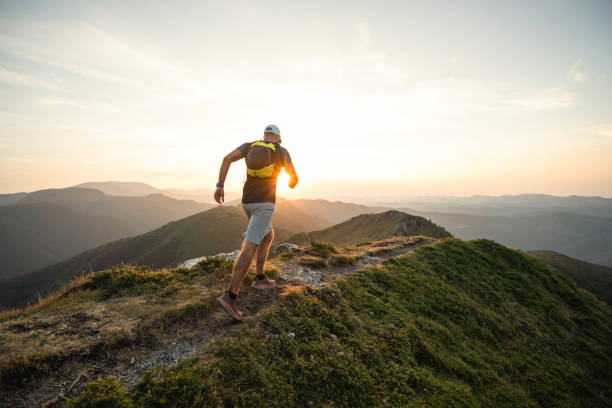 istock Male runner is jogging on the ridge of a mountain. 2170402441
