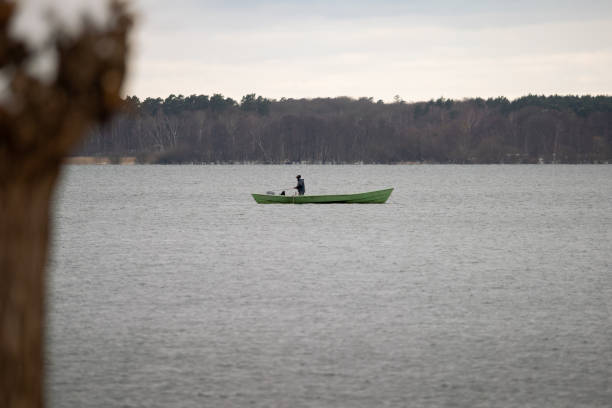 Fisherman on the famous Sevan lake in Armenia also called Gegham lake is the biggest lake in Armenia and provide irrigation water low cost electricity fish recreation and tourism.