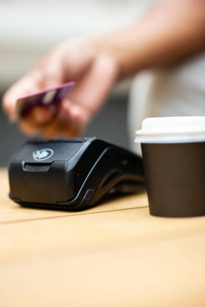 istock Young Latin man paying for a coffee on a terrace 2170411061