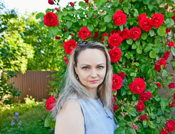 Beautiful woman in spring with beautiful flowers roses.