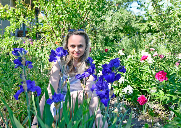 Beautiful woman in spring with beautiful iris flowers.