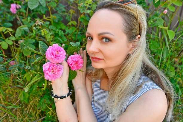 Beautiful woman in spring with beautiful flowers roses.