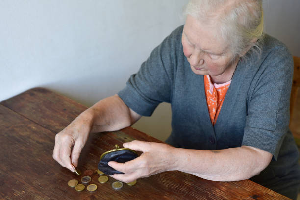 istock Old woman counting money. 2170416661