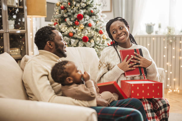 Happy family, parents and holding child in home with connection, support or bonding together. People, mother or father with daughter in apartment for comfort, peaceful moment or healthy relationship.