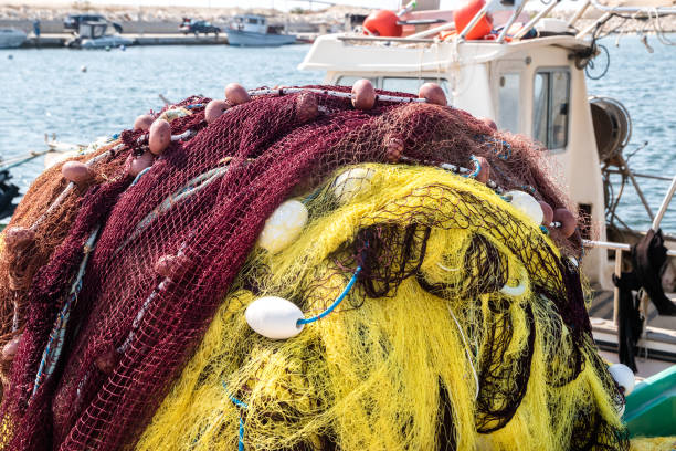 Pile of yellow fishing net in fishing boat closeup