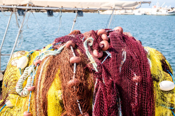 Pile of yellow fishing net in fishing boat closeup