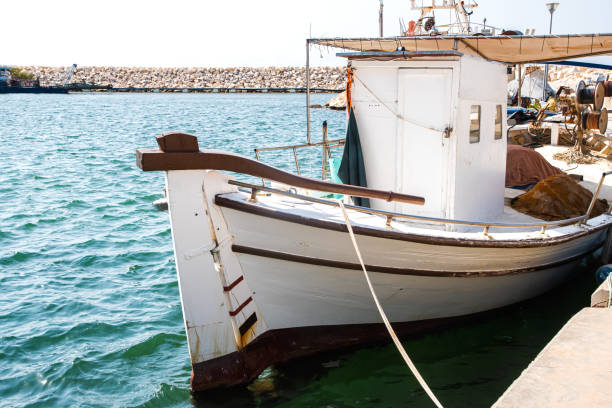 Old vintage fishing boat in Mediterranean port on sunny summer day