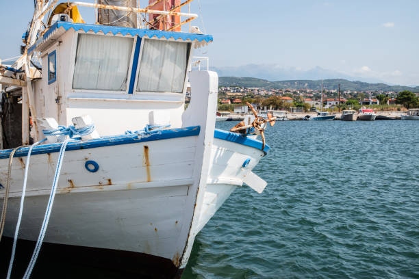 Old vintage fishing boat in Mediterranean port on sunny summer day