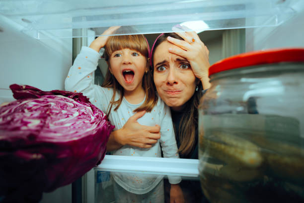istock Mother and Daughter Feeling Hungry Looking in the Refrigerator 2170434235