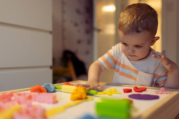 istock Little boy playing and creating from modeling clay or plasticine 2170435794