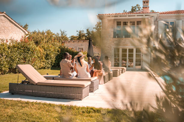 istock Sunny Idyllic Daytime Villa Poolside Party with Diverse Friends 2170436930
