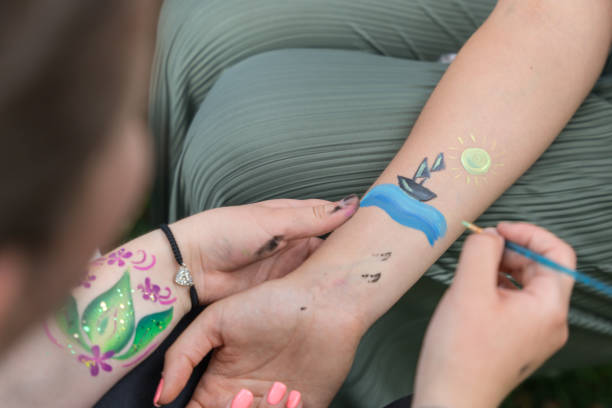 istock Young girls draw paint on arms 2170437275