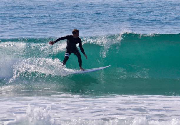istock Surfer at Speed on a Sunlit Green Wave 2170440322