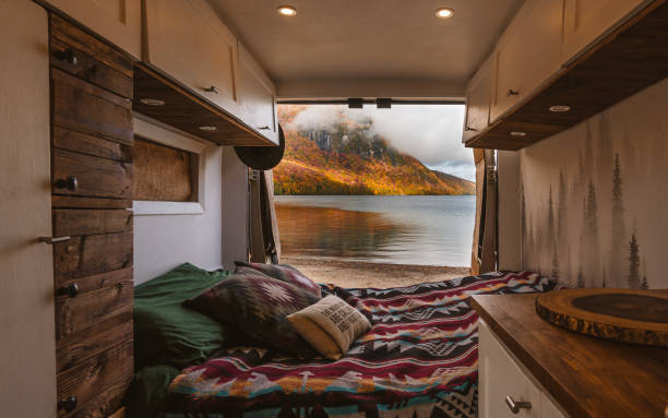 istock Vanlife Interior Camping at Lake Doors Open Fall Foliage Vermont in Autumn. Custom Camper Van Build Beautiful View Doors Open Travel Fresh Air 2170441602