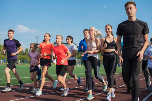 istock Group of young athletes training at the stadium 2170443859