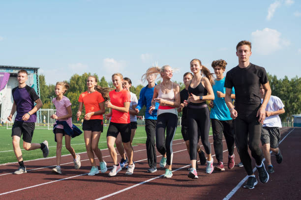 istock Group of young athletes training at the stadium 2170443862