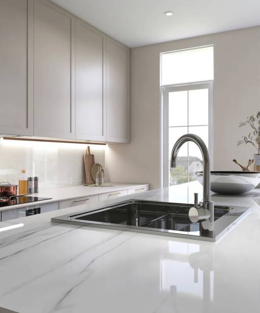 istock White marble kitchen island in modern, luxury kitchen with beige built in cabinet, cupboard in sunlight from window 2170444069