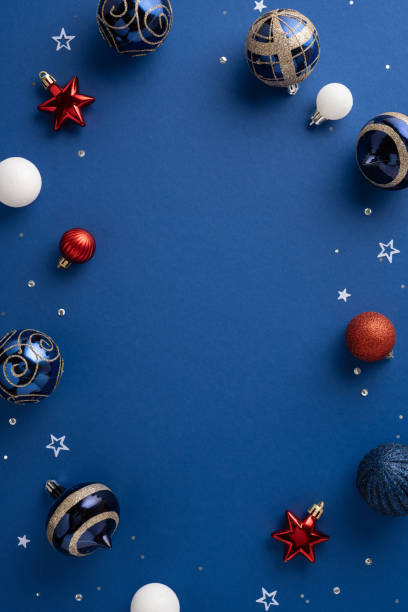 istock Festive Christmas vertical baubles and stars arranged on a vibrant blue background, creating a joyful holiday atmosphere with touches of red, white, and gold 2170445523