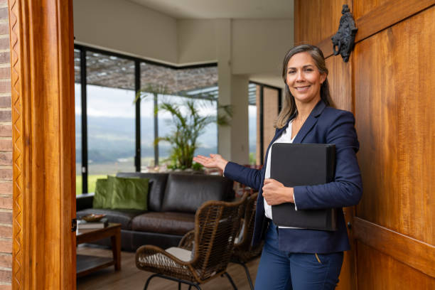 istock Real estate agent welcoming clients for a house showing 2170446027