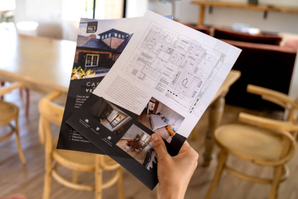 istock Close-up on a client at a house showing holding brochures 2170446103