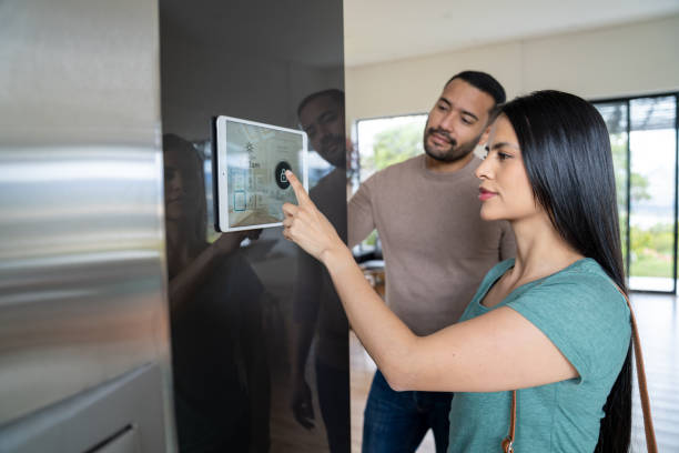 istock Couple leaving their house and locking the door using an automation system 2170446125