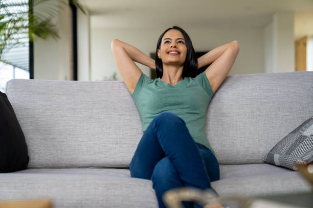 istock Woman relaxing at home sitting on the sofa 2170446151