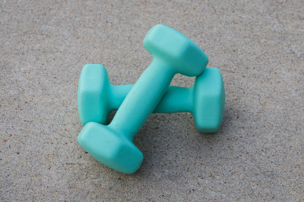 istock Two turquoise dumbbells on concrete background 2170448557