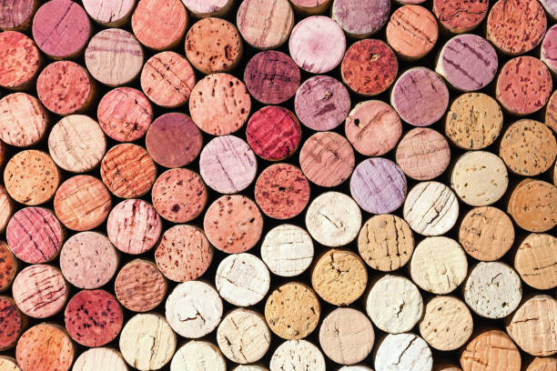 istock Wine cork background from red and white wine, natural texture used bottle stoppers top view. Closeup wooden corks. Natural textured stoppers colored wallpaper. Bright background wine corks 2170454105