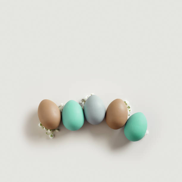 istock Pastel Easter Eggs as minimal pattern with white blooming Flowers on beige color, top view colorful chicken egg. Easter celebration concept. Festive food, still life holiday, aesthetic flat lay 2170454209