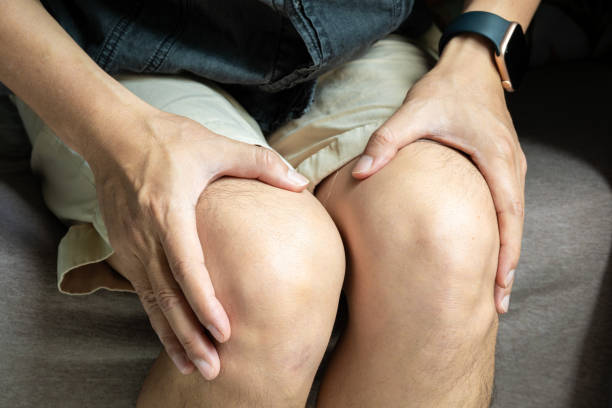 istock Knee pain man He puts his hands on his knees, pain points from osteoarthritis and bone diseases, medical concepts and treatments. 2170456098