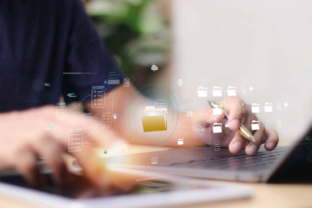 istock Document management system DMS, Enterprise content management, Businessman working on laptop computer with digital document, managing files data, paperless workflow, data search, cloud technology 2170456477