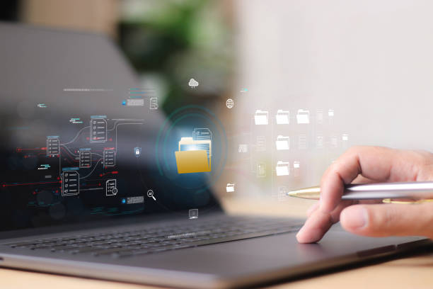 istock Document management system DMS, Enterprise content management, Businessman working on laptop computer with digital document, managing files data, paperless workflow, data search, cloud technology 2170456483