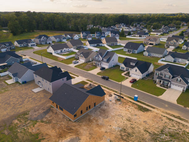 istock Developing Neighborhood - House Under Construction next to Finished Homes 2170456722