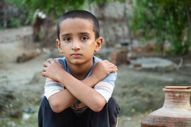 istock Thoughtful Young Boy Sitting in a Rural Outdoor Setting 2170458943
