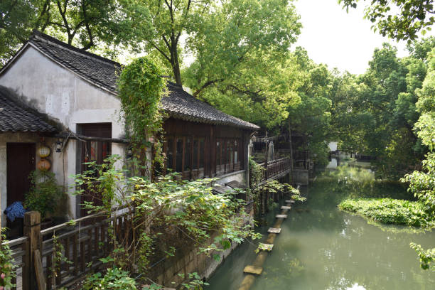 the stone riverside house in Wuzhen, a historic scenic town in China the stone riverside housing in Wuzhen, part of Tongxiang, located in the north of Zhejiang Province, China water town zhouzhuang china stock pictures, royalty-free photos & images