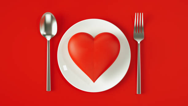 istock Romantic Valentine's Day Setting with Red Heart on White Plate, Fork, and Knife on Red Background, 3D Rendering 2170461815