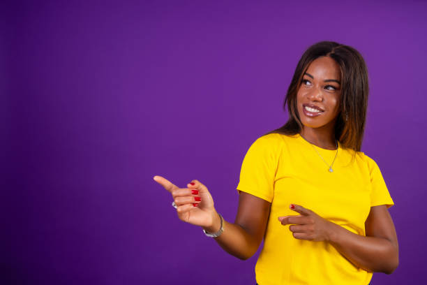 istock Happy african woman pointing a blank space to the side 2170462432