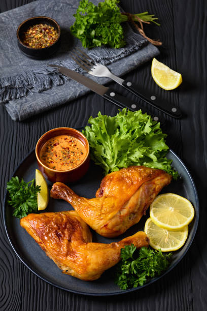 istock fried chicken legs with lettuce, lemon on plate 2170464959