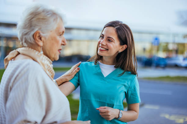 istock Smiling Nurse Comforting Elderly Woman Outdoors During Daytime 2170467845