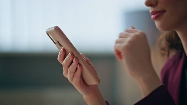 istock Closeup businesswoman holding mobile phone resting in office. Hands using cell 2170469290