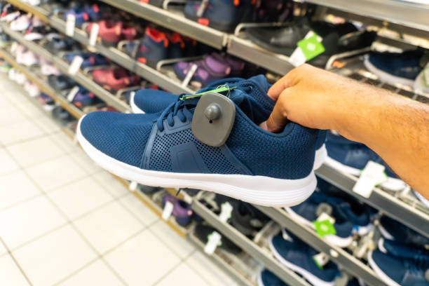 istock A person is holding a blue shoe with a tag on it 2170471482