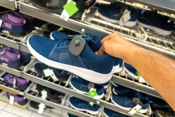 istock A person is holding a blue shoe with a tag on it 2170471497
