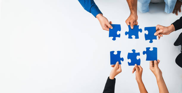 istock Business team joining jigsaw puzzle together. Prudent 2170472232