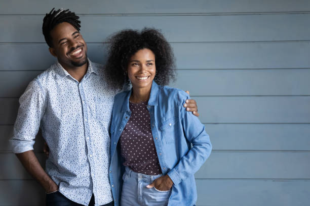 istock Happy dreamy African American couple on grey studio wall background 2170472886