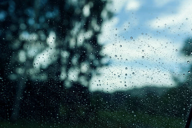 istock raindrops on the window pane, clouds behind the glass, raining 2170474156