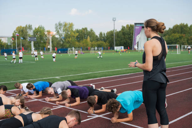 istock Female coach and group of children conducts a training session 2170475178