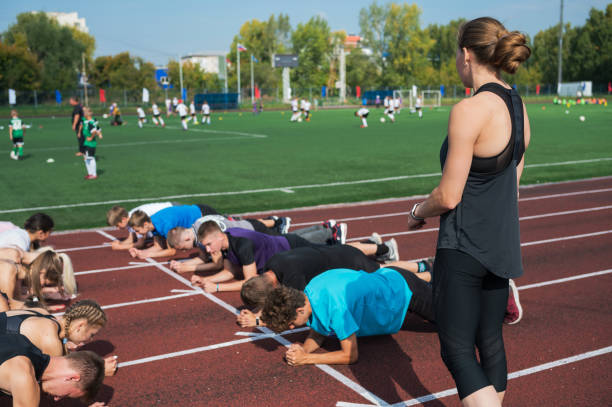 istock Female coach and group of children conducts a training session 2170475189