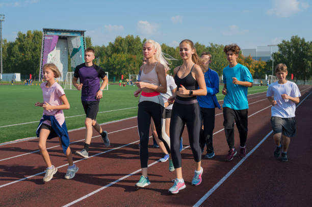 istock Group of young athletes training at the stadium 2170475219