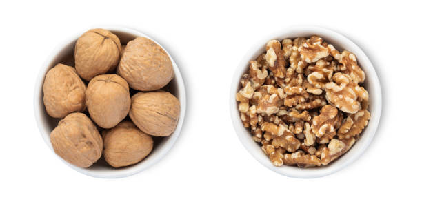 istock Bowls with organic walnut nuts isolated on white background.Top view. 2170475381