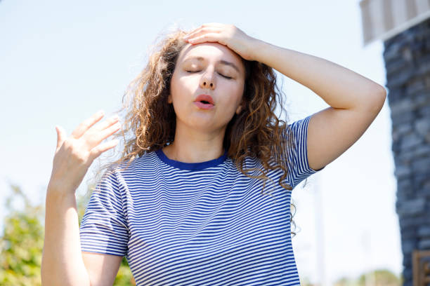 istock Young woman having hot flash and sweating in a warm summer day 2170476193